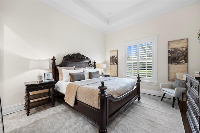 bedroom with a raised ceiling, baseboards, and ornamental molding