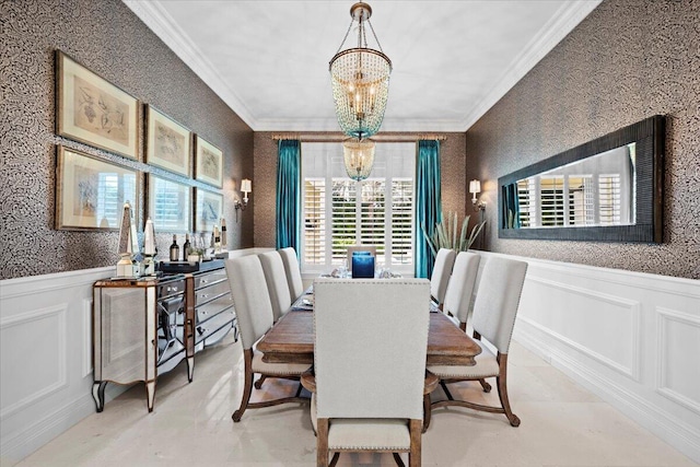 dining room featuring wallpapered walls, a wainscoted wall, crown molding, and an inviting chandelier