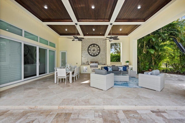 view of patio featuring outdoor dining area, an outdoor kitchen, a grill, ceiling fan, and an outdoor living space