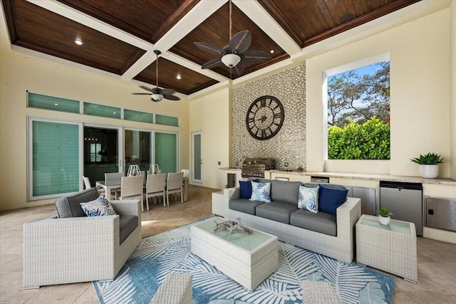 living room featuring wooden ceiling, a towering ceiling, a ceiling fan, and coffered ceiling