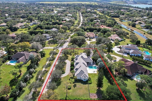 drone / aerial view featuring a water view and a residential view