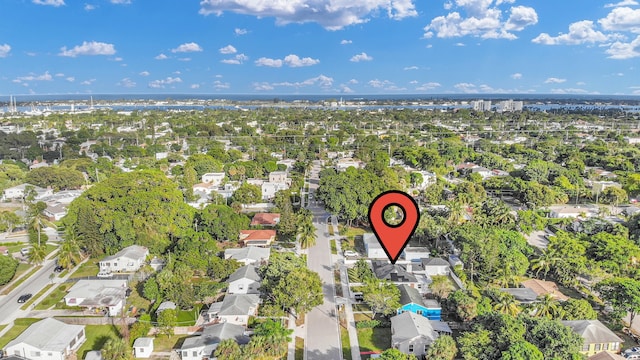 drone / aerial view with a water view and a residential view