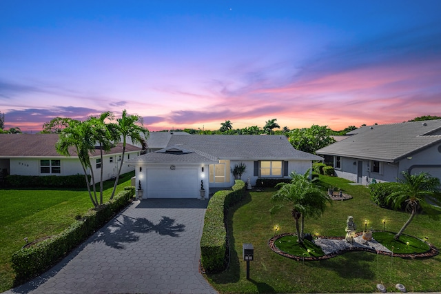 7119 NW 106th Ave, Tamarac, FL 33321 - ranch-style home featuring decorative driveway, an attached garage, a yard, and stucco siding