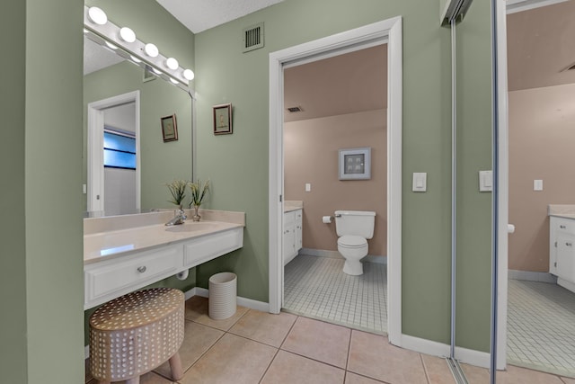 full bathroom featuring vanity, visible vents, and tile patterned floors