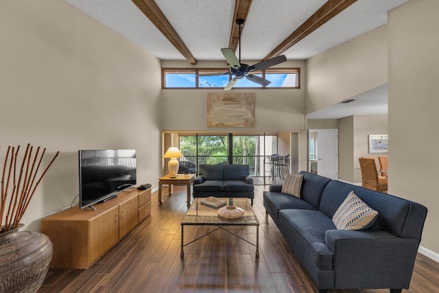 living area with dark wood-style floors, plenty of natural light, and a textured ceiling