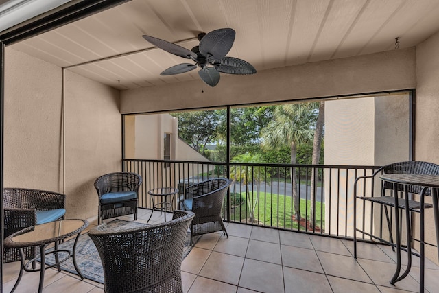 sunroom / solarium featuring ceiling fan