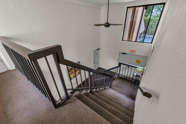 washroom with a textured ceiling, washing machine and dryer, laundry area, baseboards, and dark wood-style floors