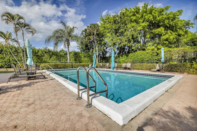 view of swimming pool with a fenced in pool, a patio area, and fence