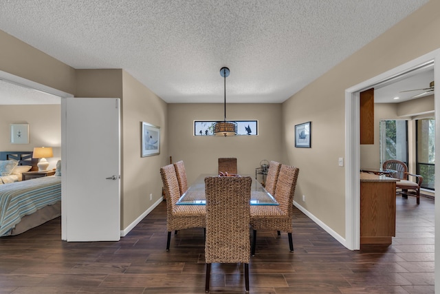 dining area with dark wood finished floors, a textured ceiling, and baseboards