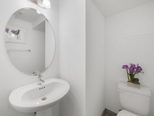 half bath with toilet and a sink