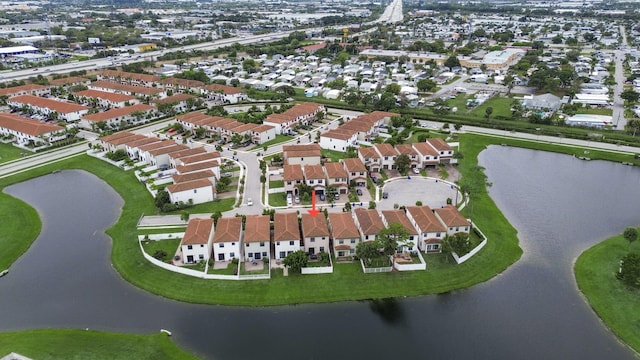 aerial overview of property's location with a nearby body of water and nearby suburban area