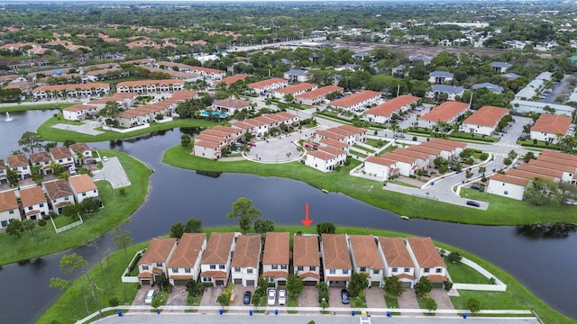 view of property location featuring a nearby body of water and nearby suburban area