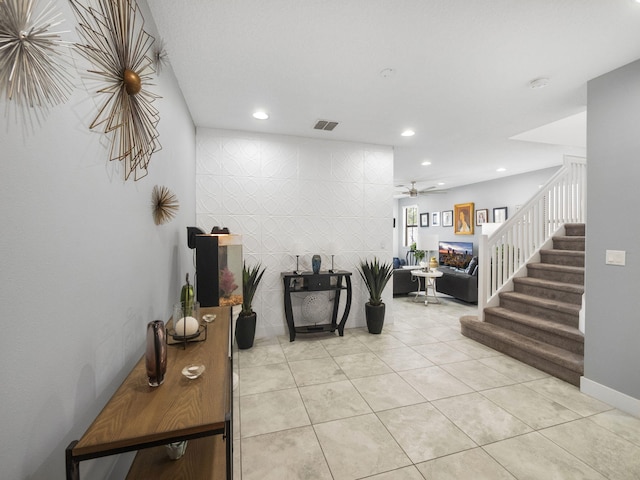 hallway with stairs, recessed lighting, and light tile patterned flooring
