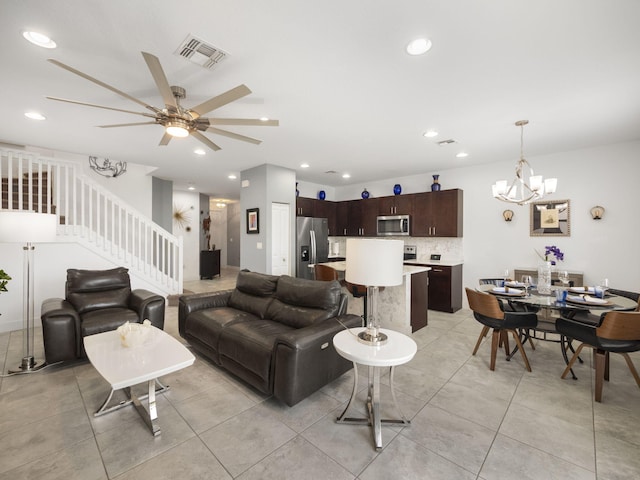 living area with a ceiling fan, light tile patterned flooring, a chandelier, stairs, and recessed lighting