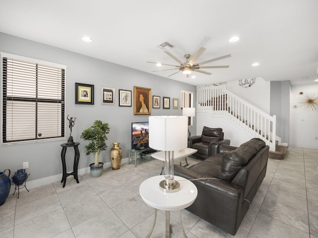 living room featuring stairs, a ceiling fan, baseboards, light tile patterned floors, and recessed lighting