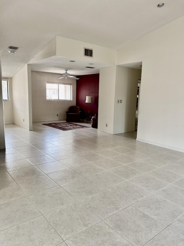 10694 Ocean Palm Way Unit 202, Boynton Beach, FL 33437 - unfurnished room with ceiling fan, baseboards, and light tile patterned floors
