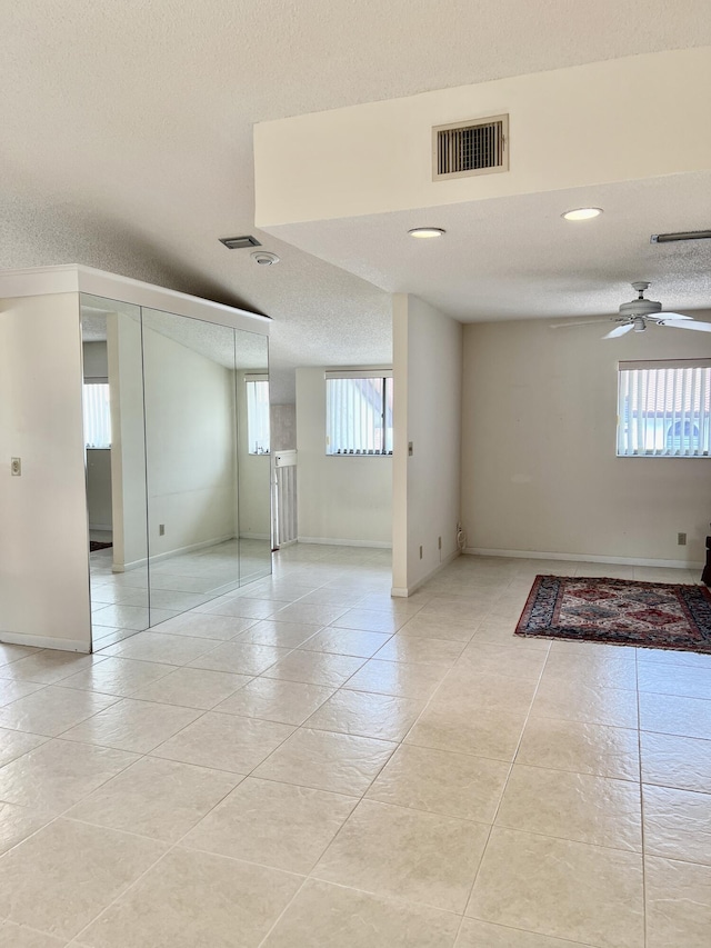 10694 Ocean Palm Way Unit 202, Boynton Beach, FL 33437 - spare room with light tile patterned flooring, baseboards, ceiling fan, recessed lighting, and a textured ceiling