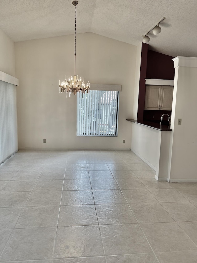 10694 Ocean Palm Way Unit 202, Boynton Beach, FL 33437 - unfurnished dining area featuring a chandelier, a textured ceiling, track lighting, high vaulted ceiling, and a sink