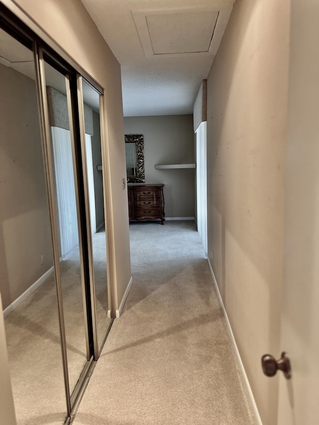 10694 Ocean Palm Way Unit 202, Boynton Beach, FL 33437 - corridor with light colored carpet and baseboards