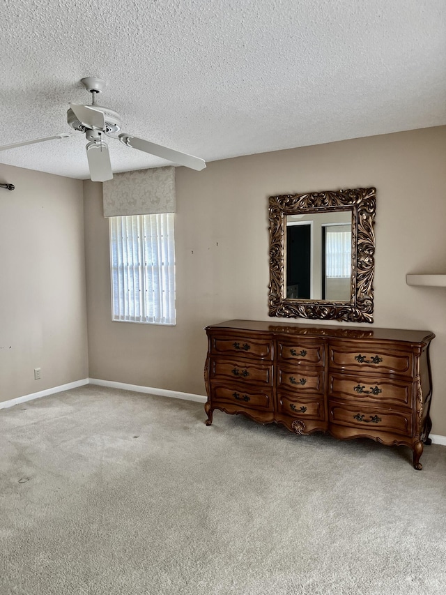 10694 Ocean Palm Way Unit 202, Boynton Beach, FL 33437 - bedroom with carpet flooring, ceiling fan, baseboards, and a textured ceiling