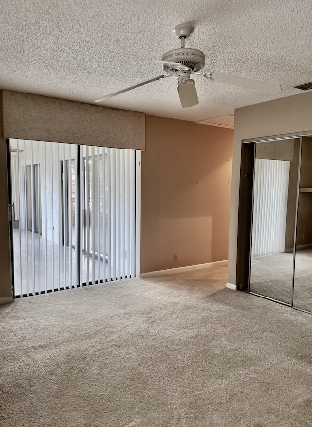10694 Ocean Palm Way Unit 202, Boynton Beach, FL 33437 - carpeted empty room with a ceiling fan, baseboards, and a textured ceiling