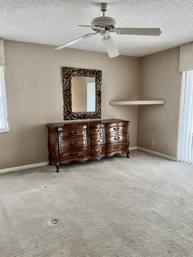 10694 Ocean Palm Way Unit 202, Boynton Beach, FL 33437 - carpeted bedroom featuring a textured ceiling, a ceiling fan, and baseboards