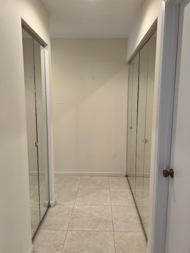 10694 Ocean Palm Way Unit 202, Boynton Beach, FL 33437 - hall featuring light tile patterned floors and baseboards