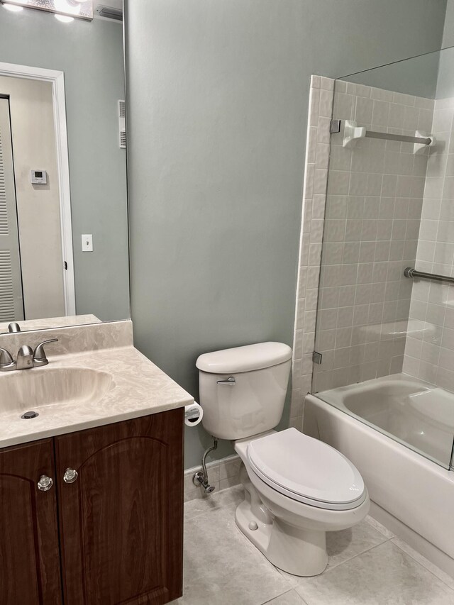 10694 Ocean Palm Way Unit 202, Boynton Beach, FL 33437 - full bathroom featuring shower / tub combination, toilet, vanity, tile patterned floors, and baseboards