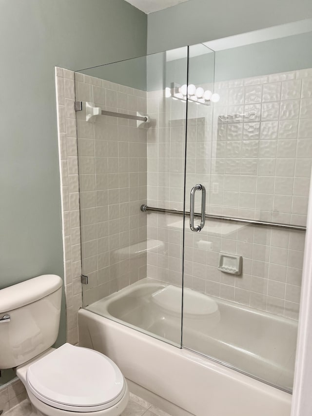 10694 Ocean Palm Way Unit 202, Boynton Beach, FL 33437 - full bathroom featuring combined bath / shower with glass door, toilet, and tile patterned flooring