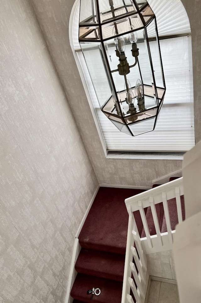 10694 Ocean Palm Way Unit 202, Boynton Beach, FL 33437 - stairs featuring a chandelier