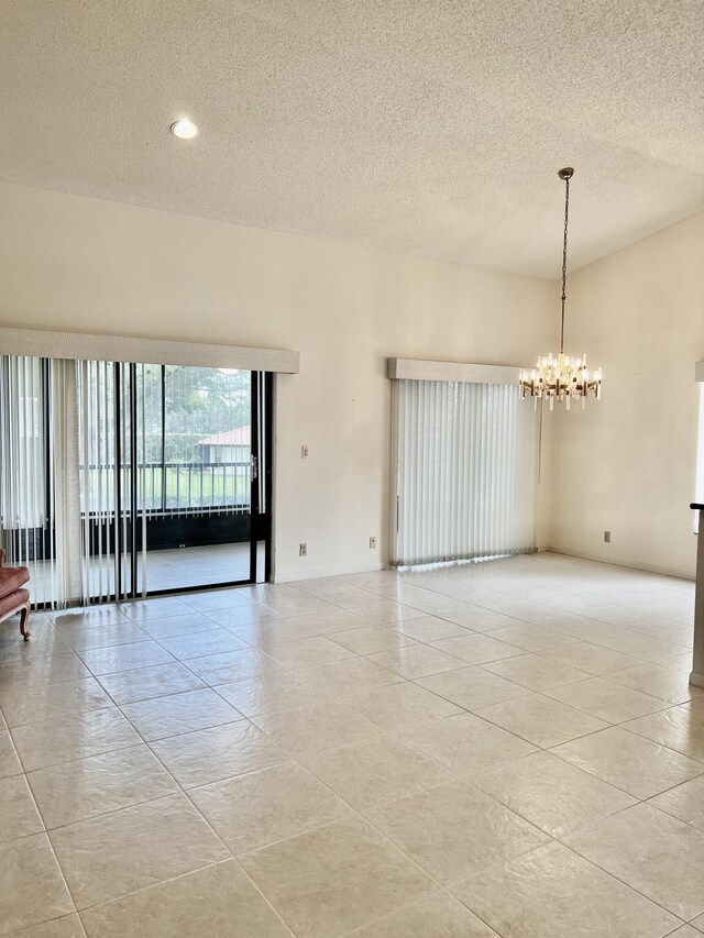 10694 Ocean Palm Way Unit 202, Boynton Beach, FL 33437 - unfurnished room with a textured ceiling, a chandelier, light tile patterned floors, and recessed lighting