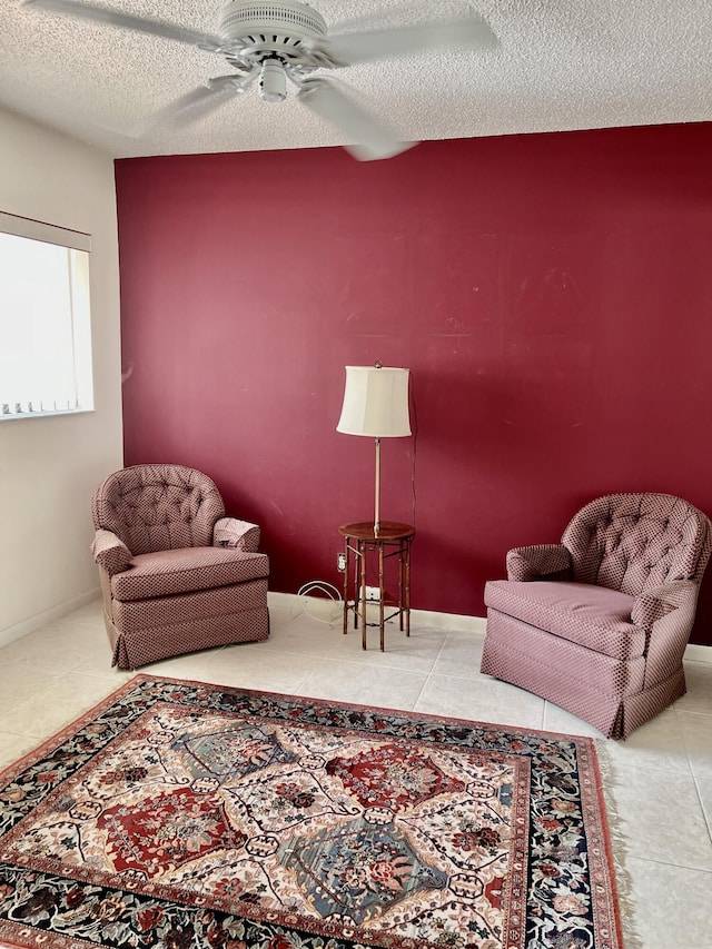 10694 Ocean Palm Way Unit 202, Boynton Beach, FL 33437 - living room featuring a ceiling fan, a textured ceiling, and tile patterned flooring