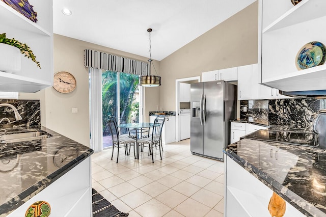 kitchen with lofted ceiling, a sink, white cabinetry, open shelves, and stainless steel fridge