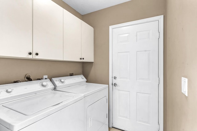 washroom featuring washer and dryer and cabinet space