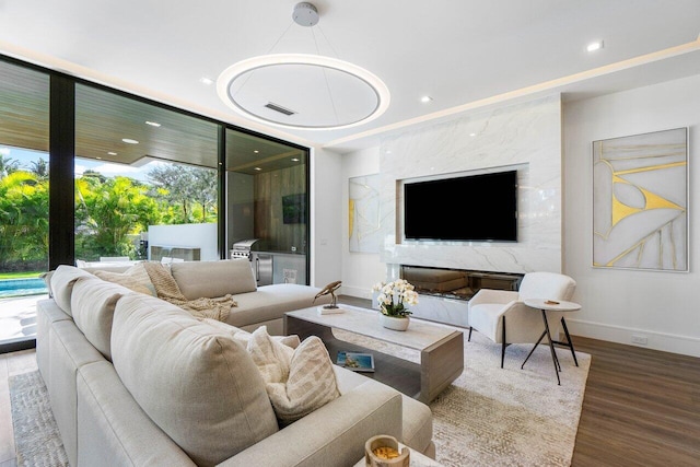 living room featuring baseboards, wood finished floors, and recessed lighting