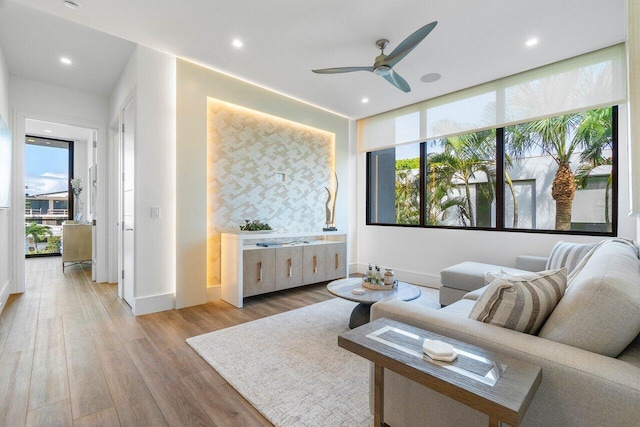 living area with plenty of natural light, ceiling fan, wood finished floors, and recessed lighting