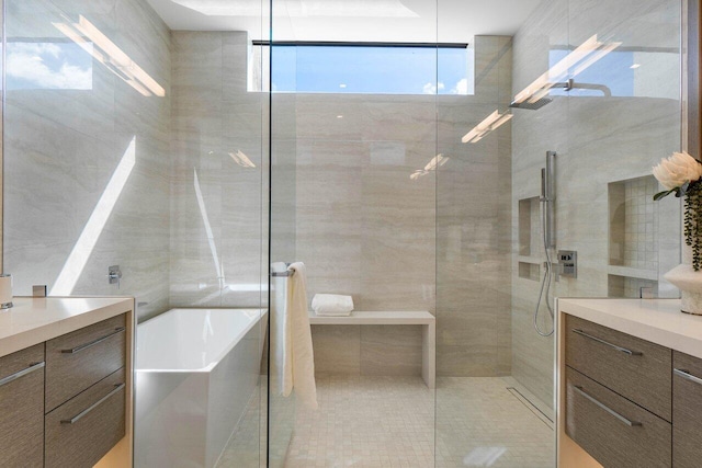 bathroom with a freestanding tub, vanity, and walk in shower