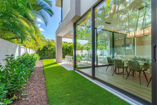 exterior space with a patio, fence, and visible vents