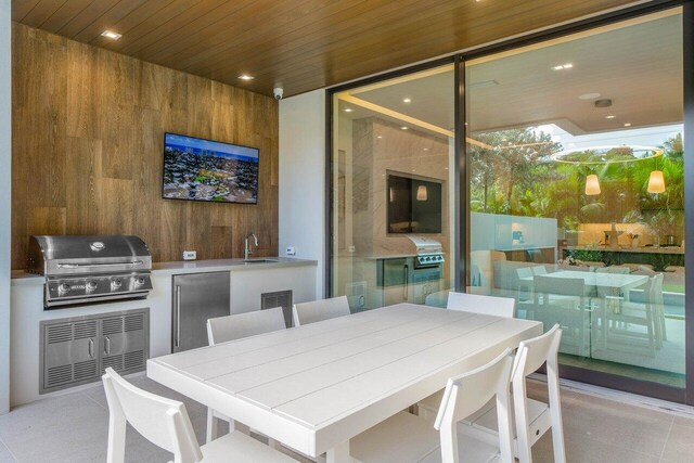 dining room with wood walls, wood ceiling, wet bar, and tile patterned flooring