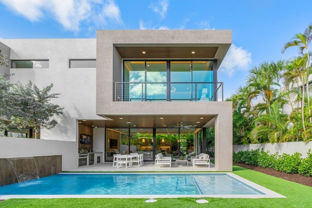 back of house featuring a fenced in pool, stucco siding, a patio area, fence, and a balcony