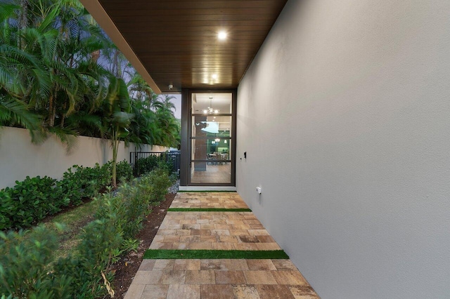 doorway to property with fence and stucco siding