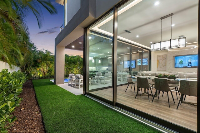 exterior space featuring outdoor dining space, a lawn, and visible vents