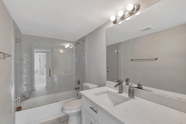 bathroom with visible vents, toilet, enclosed tub / shower combo, marble finish floor, and vanity