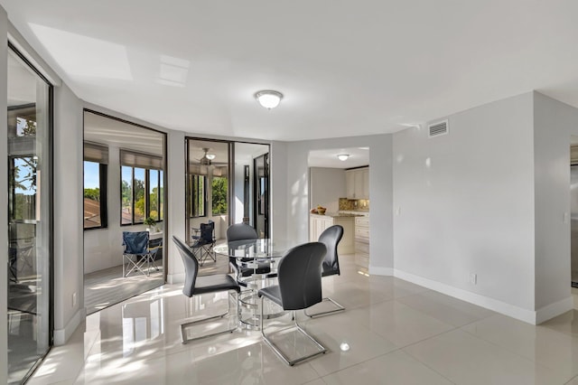 office space featuring light tile patterned floors, baseboards, and visible vents