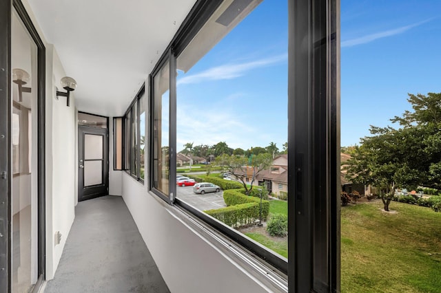 hallway featuring concrete floors and a residential view