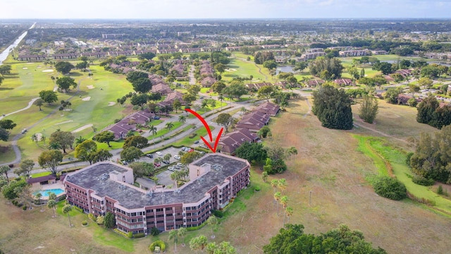 birds eye view of property with view of golf course