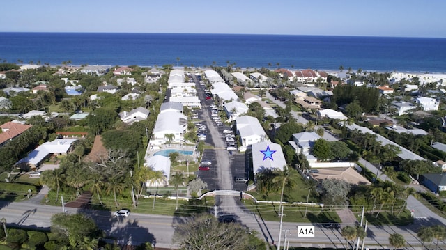 birds eye view of property with a water view and a residential view