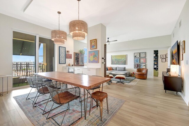 dining area featuring light wood-style floors and ceiling fan