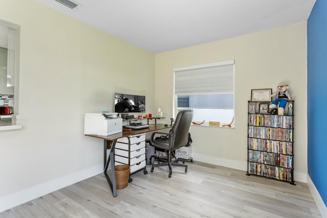 office featuring light wood-style flooring, visible vents, and baseboards