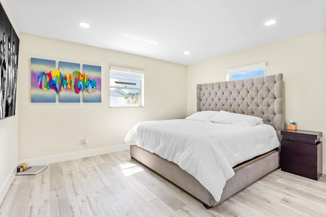 bedroom with recessed lighting, light wood-type flooring, and baseboards